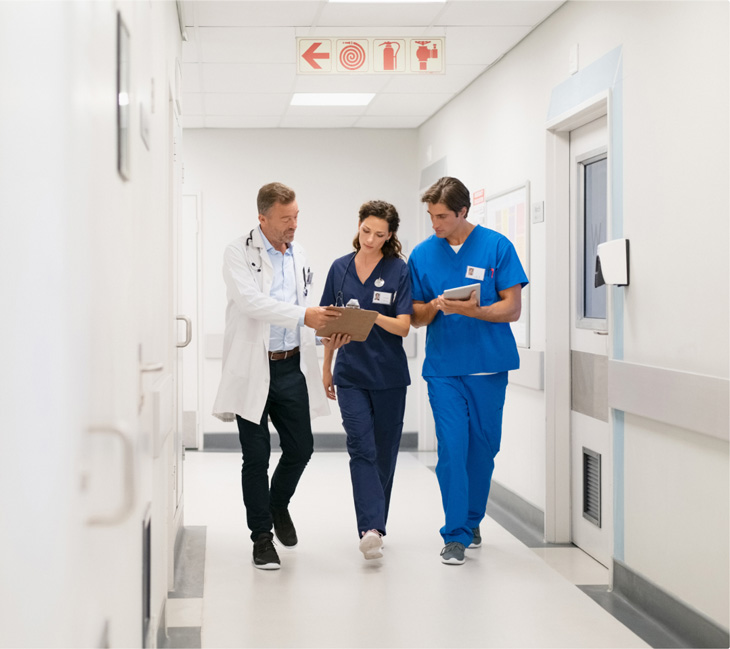 three doctors in hospital corridor